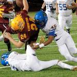 Bremertons Keith Jackmon (9) and Kaipo Retome (45) collide with Kingstons Garrett Sitting-Dog (24) in the first quarter of the Knights 30-20 victory. (Mark Krulish/Kitsap News Group)