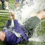North Kitsap head coach Jeff Weible unsuccessfully tries to get away from an impending Gatorade shower after his team clinched the Olympic League championship. (Mark Krulish/Kitsap News Group)
