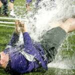 North Kitsap head coach Jeff Weible unsuccessfully tries to get away from an impending Gatorade shower after his team clinched the Olympic League championship. (Mark Krulish/Kitsap News Group)