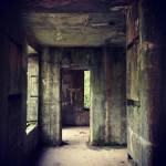 A long-abandoned storage facility for munition remote controls stands resolutely against the weather despite having had its windows and doors removed decades ago. (Bob Smith | Kitsap Daily News)