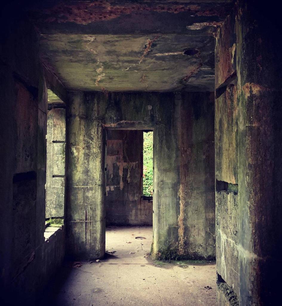 A long-abandoned storage facility for munition remote controls stands resolutely against the weather despite having had its windows and doors removed decades ago. (Bob Smith | Kitsap Daily News)