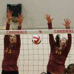 Morgan Halady (13) and Abby Steele (10) of Kingston team up for a block attempt against Fife. (Mark Krulish/Kitsap News Group)