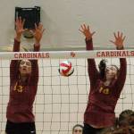 Morgan Halady (13) and Abby Steele (10) of Kingston team up for a block attempt against Fife. (Mark Krulish/Kitsap News Group)