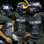 Manny Oliveros (58) and Aidan King (1) celebrate with North Kitsap quarterback Colton Bower after his third touchdown tied their playoff game against Fife in the fourth quarter. (Mark Krulish/Kitsap News Group)