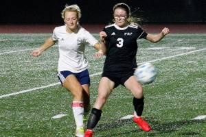 Klahowyas Sarah Newhard battles with a Lynden Christian player for the ball during their state tournament game. (Mark Krulish/Kitsap News Group)