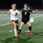 Klahowyas Sarah Newhard battles with a Lynden Christian player for the ball during their state tournament game. (Mark Krulish/Kitsap News Group)