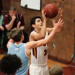 South Kitsaps John Walters goes up and over a Curtis defender for a basket. (Mark Krulish/Kitsap News Group)