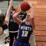 North Kitsaps Grace Johnson takes a shot over Ellie Woolever of Bainbridge (23) in her teams 53-45 victory on Dec. 9. (Mark Krulish/Kitsap News Group)