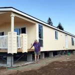 Skip Olmsted, who lives on Southeast Serenade Way, inspects his new manufactured home that replaces his old place destroyed by last Decembers tornado. (Robert Zollna | Kitsap Daily News)