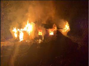 An abandoned home along Viking Way was fully engulfed in flames on Christmas Eve. (photo courtesy of Poulsbo Fire)