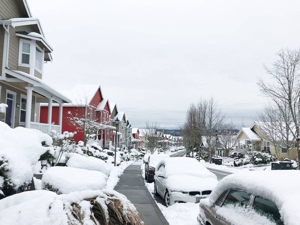 The snow contrasts the colorful homes along Jensen Street.