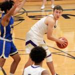 North Kitsaps Logan Chmielewski looks for an open teammate as he is defending by Bremertons Kimo Retome. Chmielewski finished his teams 84-55 win over the Knights with 12 points. (Mark Krulish/Kitsap News Group)