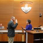 Mayor Erickson swears in new council members Britt Livdahl and Andrew Phillips. (Photos by Ken Park)