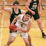 Aiden Olmstead looks for an open teammate while Port Angeless John Vaara applies the pressure. (Mark Krulish/Kitsap News Group)