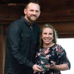 Camie Yeik Devitt receives her Hall of Fame award from Kitsap Athletic Roundtable President Noah Garguile. (Mark Krulish/Kitsap News Group)