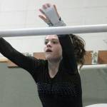 North Kitsaps Alivia Palmer makes a leap for the high bar during a dual meet against Kingston. (Mark Krulish/Kitsap News Group)