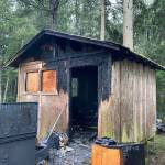<em>NKF&R crews quickly extinguished a fire, thought to have been sparked by a cellphone charging cord, in a sleeping cabin near Kingston on Wednesday morning but were unable to save two pet reptiles trapped inside.</em>Photo courtesy of NKF&R