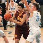 South Kitsaps Jonathan Walters looked for a way to the hoop while sandwiched by two Rogers defenders in their tiebreaker game Saturday. (Mark Krulish/Kitsap News Group)