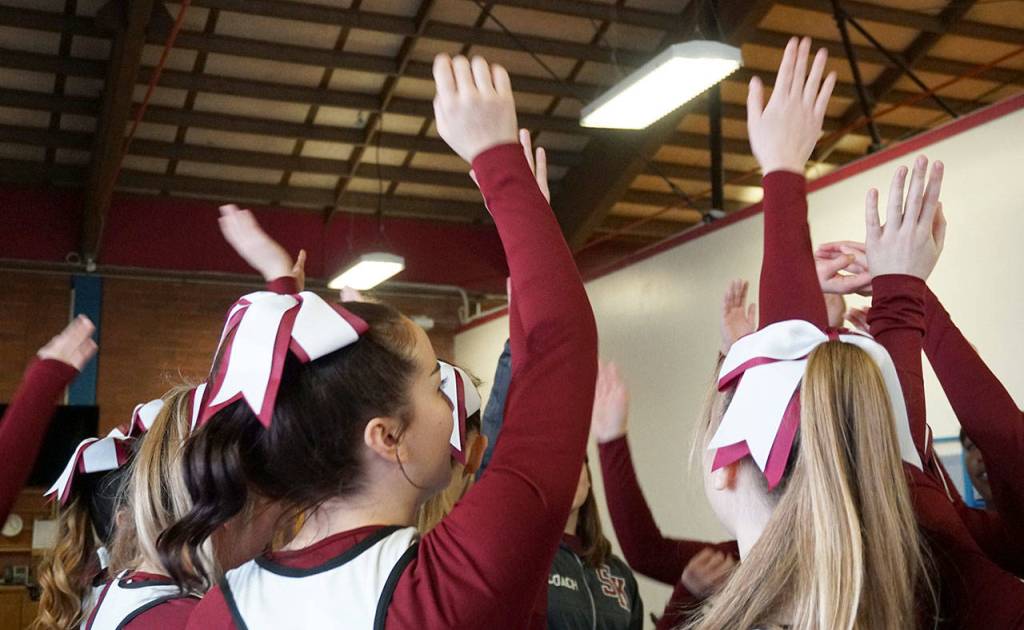 Its hands up after a South Kitsap cheer squad routine. (Bob Smith | Kitsap Daily News)
