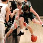Peninsulas Cole McVay and Central Kitsaps Colby White battle for a loose ball in the first quarter of their district playoff game. (Mark Krulish/Kitsap News Group)