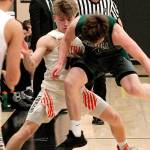 Peninsulas Cole McVay and Central Kitsaps Colby White battle for a loose ball in the first quarter of their district playoff game. (Mark Krulish/Kitsap News Group)