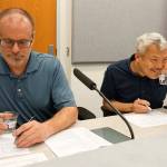 Port Orchard City Council members Scott Diener (left) and Fred Chang evaluate water samples in a blind taste test. (Bob Smith | Kitsap Daily News)