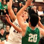 North Kitsaps Logan Chmielewski tries to get a shot up and over Tumwaters big forward Damon Gaither at regionals. (Mark Krulish/Kitsap News Group)