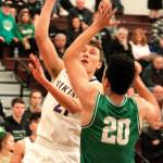 North Kitsaps Logan Chmielewski tries to get a shot up and over Tumwaters big forward Damon Gaither at regionals. (Mark Krulish/Kitsap News Group)