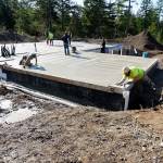 Pavers finish smoothing poured cement for the foundation of Keith Sekoras new home, now under construction in South Kitsap. The specially designed home will accommodate Sekoras special needs, all on one floor. It is being paid for by the nonprofit organization Homes for Our Troops. (Mike De Felice | Kitsap Daily News)