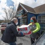 Frank Wilson, Kitsap Regional Manager for John L. Scott, helps collect donations for the John L. Scott Poulsbo offices recent food drive. In all, the five-hour drive amounted to 1,485 pounds of food and $2,710 in cash donations. (Photo courtesy of John L. Scott)