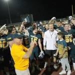 The Bainbridge football team, shown here celebrating their 2019 Agate Cup win over North Kitsap, will have to wait until March of 2021 to get a chance to defend the cup. (Review file photo)