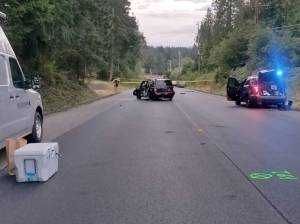 The crash scene, facing northbound, with the Jeep Patriot in the center. (Photo courtesy Kitsap County Sheriffs Office)