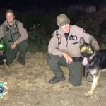 Bright-eyed K-9 Cooper and his handler, Dep. A. Baker of Kitsap County Sheriffs Office (at right), pose alongside K-9 Blue and his handler during a nighttime training session last week. (KCSO photo)