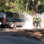 Firefighters extinguish flames that destroyed an SUV in the LNV Lightning Complex fire in Northern California.                                (Photo courtesy of the South Puget Sound Strike Team)