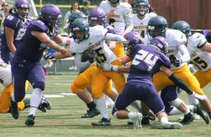 Bainbridge running back Alex Ledbetter tries to break away from the pile during the Spartans 2018 opener against North Kitsap. (File photo)
