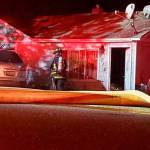 South Kitsap Fire and Rescue units check for hot spots at a residential fire on Sidney Avenue late Monday night. (Robert Zollna | Kitsap Daily News)