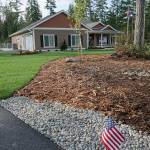Injured Air Force Reserves veteran Keith Sekora stands with others outside his newly built home in South Kitsap. The residence was paid for by the nonprofit organization Homes For Our Troops. (Bob Smith | Kitsap Daily News)