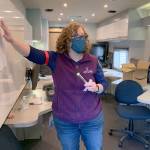 Amy Anderson with Kitsap Public Health District shows a saliva collection tube that volunteers collect at the mobile COVID-19 drive-through testing unit. (Bob Smith | Kitsap Daily News)