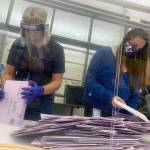Madison Andrews (right) and Allison Brazil, election workers at the Kitsap County Elections Division in Port Orchard, gather and sort arriving election ballot envelopes Monday at the countys administration building. (Bob Smith | Kitsap Daily News)