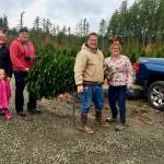 From 2019, a family successfully cuts down its own tree at the farm. Courtesy Olmstead Tree Farms