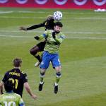 Sounders midfielder João Paulo tries to out-leap a Columbus player for the ball in the MLS Cup. (Mike Fiechtner/Sounders FC Communications)