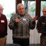 Sam Clarke, Ray Lowrie and Jim Nadeau hold up the 1948 state championship teams commemorative plaque.
