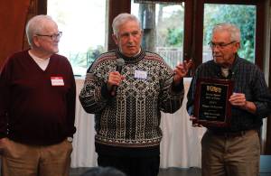 Sam Clarke, Ray Lowrie and Jim Nadeau hold up the 1948 state championship teams commemorative plaque.