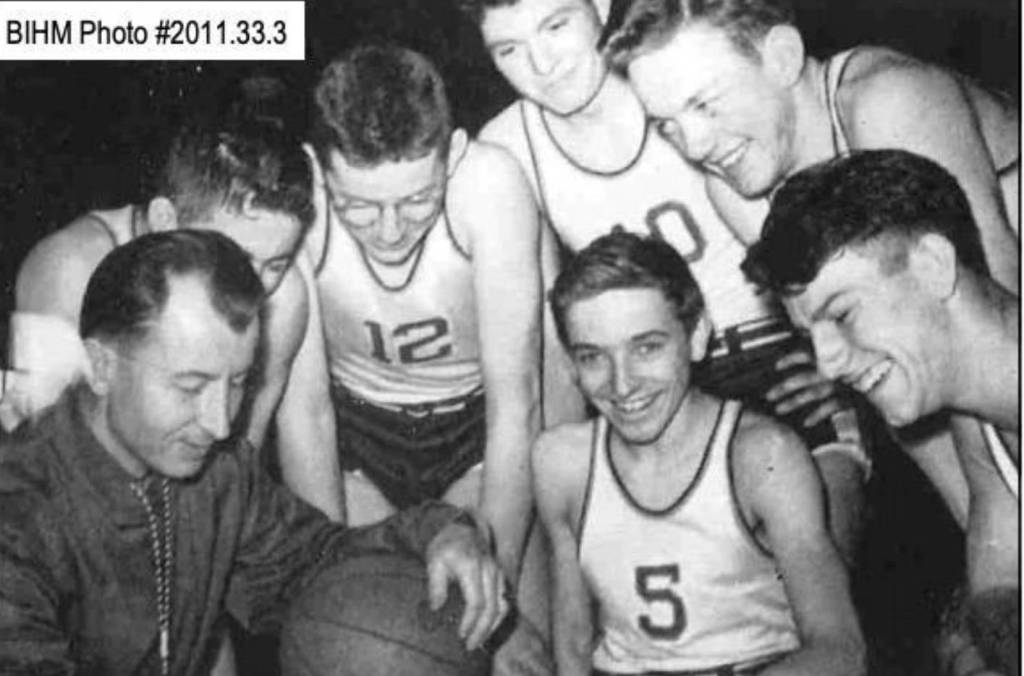<em>Bainbridge head coach Tom Paski shares the trophy with some of his players, including Bob Sigle (5), Pete Uglesich (10) and Bob Woodman (12).</em>
Photo courtesy Bainbridge Island Historical Museum
