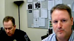 Detectives Lee Wheeler (R) and Gary Westerfield (L) discuss rising online crime rates in Poulsbo.