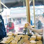 A worker at Sluys Bakery in Poulsbo shows Seattle Kraken broadcaster Everett Fitzhugh a few of their tasty treats. (Photo courtesy Seattle Kraken)