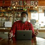 <em>Seattle Kraken radio voice Everett Fitzhugh takes a break at the Brass Kraken during a visit to Poulsbo. Below: A worker at Sluys Bakery in Poulsbo shows Fitzhugh a few of their tasty treats. </em>	 Photos courtesy Seattle Kraken