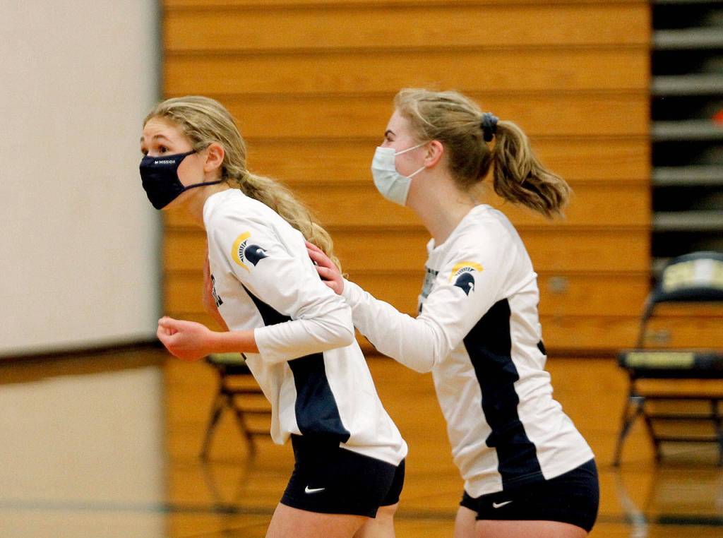 Bainbridges Rebecca Roman (left) celebrates an ace against North Kitsap. (Mark Krulish/Kitsap News Group)