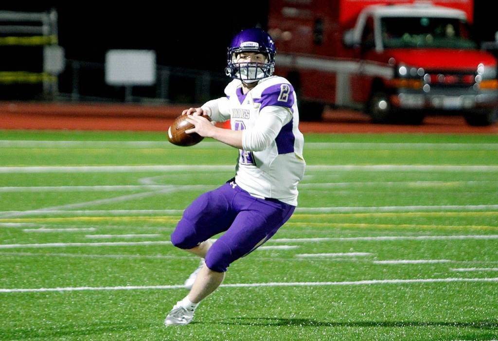 North Kitsap quarterback Colton Bower rolls out to make a throw. He passed for 161 yards and three touchdowns against Central Kitsap. (Mark Krulish/Kitsap News Group)