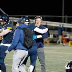 Bainbridge head coach Jeff Rouser celebrates with his team after beating Olympic. (Mark Krulish/Kitsap News Group)
